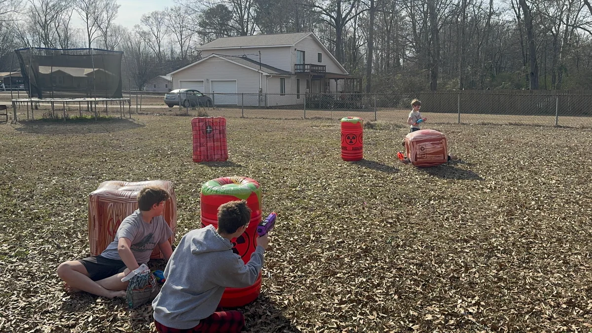 Two players taking cover behind inflatable barriers