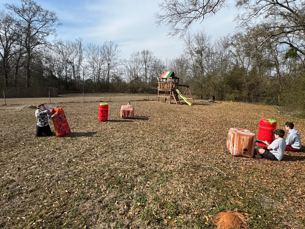 Nerf war gameplay with kids spread across the field