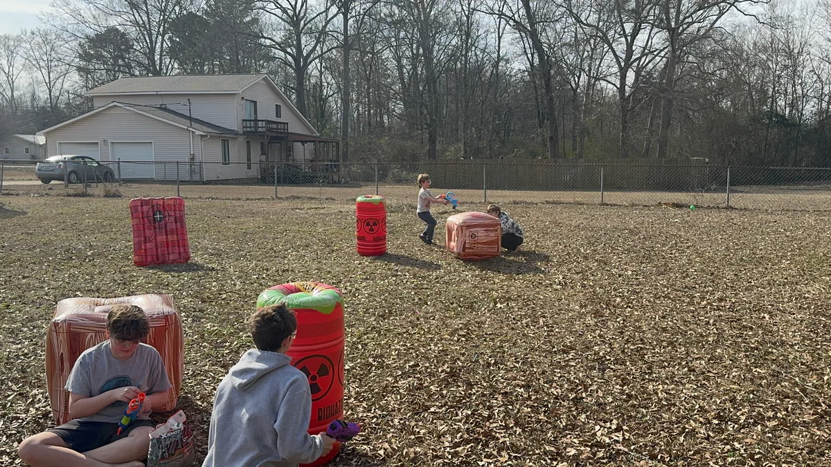 Player sprinting between inflatable barriers during a Nerf war
