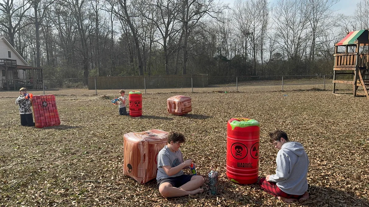 Kids setting up behind inflatable barriers for a Nerf battle